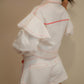 White denim jacket decorated with ruffles and red stitching