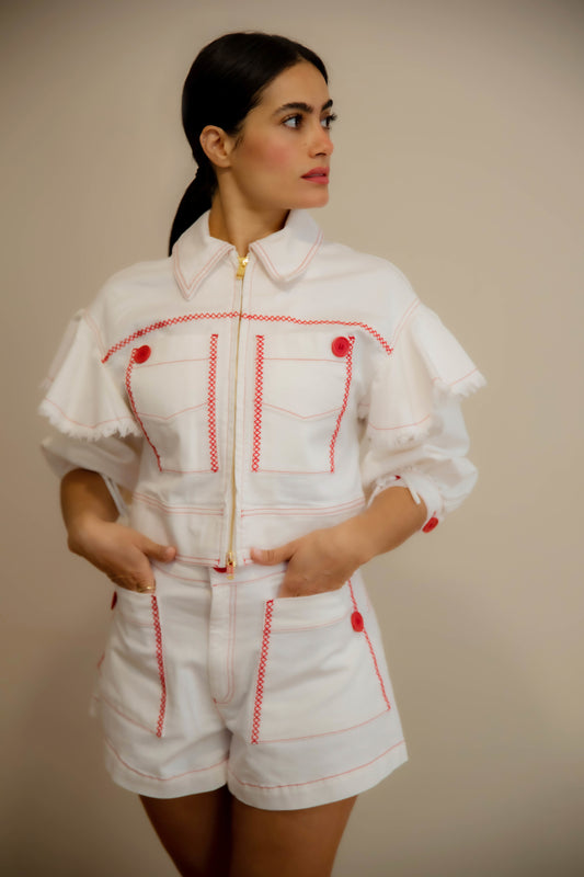 White denim jacket decorated with ruffles and red stitching